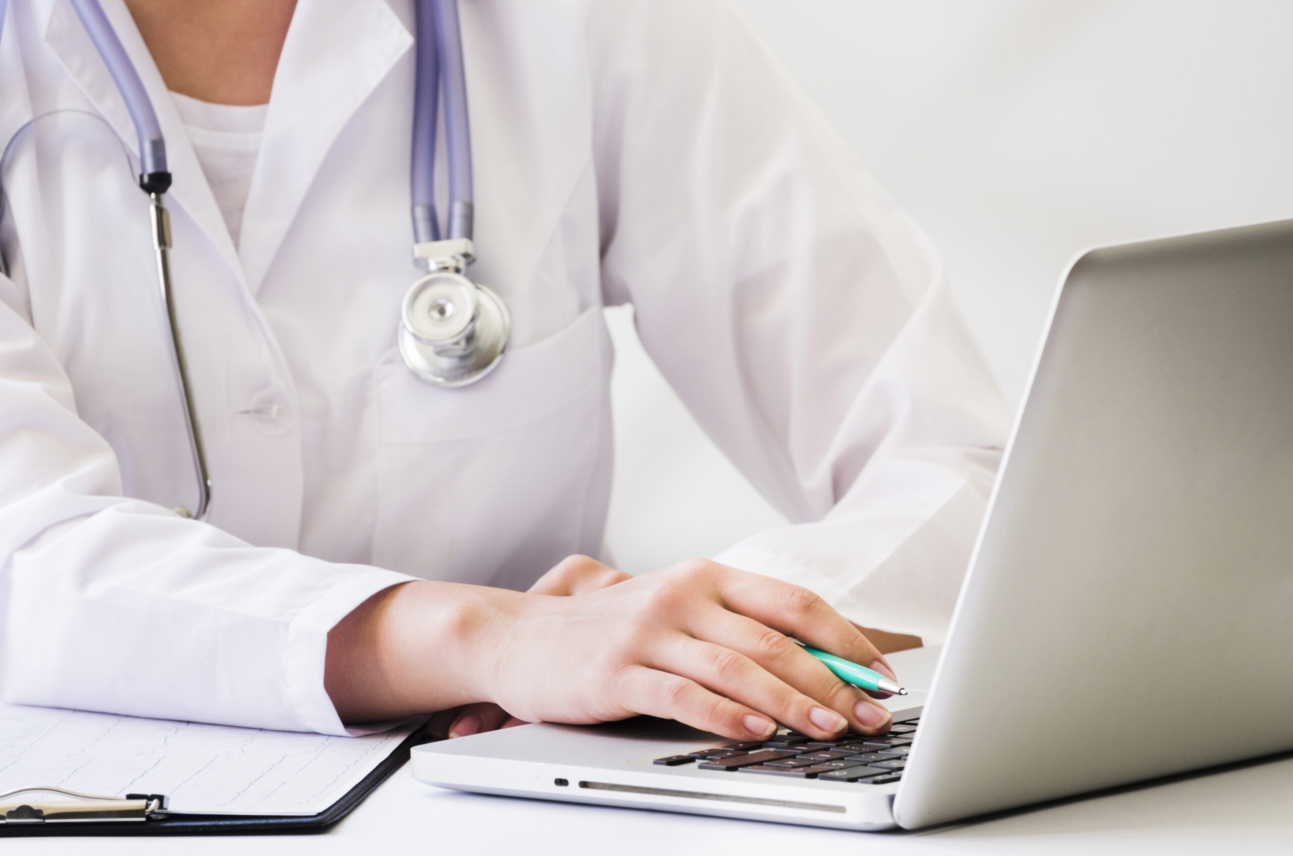 Doctor reviewing medical data on a laptop for expert annotation.