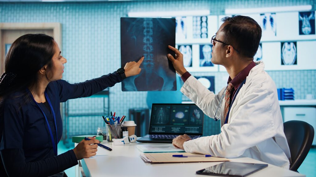 Medical professionals reviewing X-ray images to evaluate AI-assisted diagnostic outputs