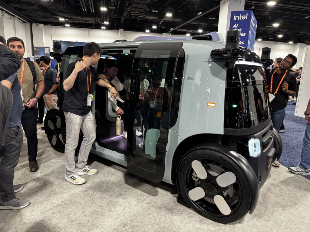 Attendees board a Zoox robotaxi at CVPR 2026