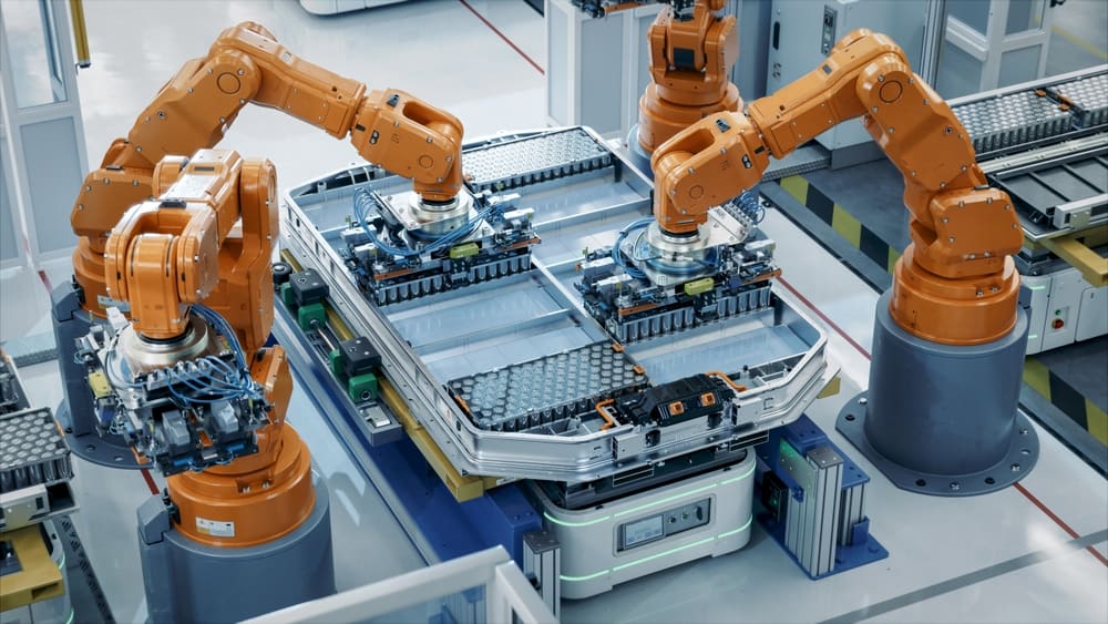 Orange Industrial Robot Arms Assemble Skateboard