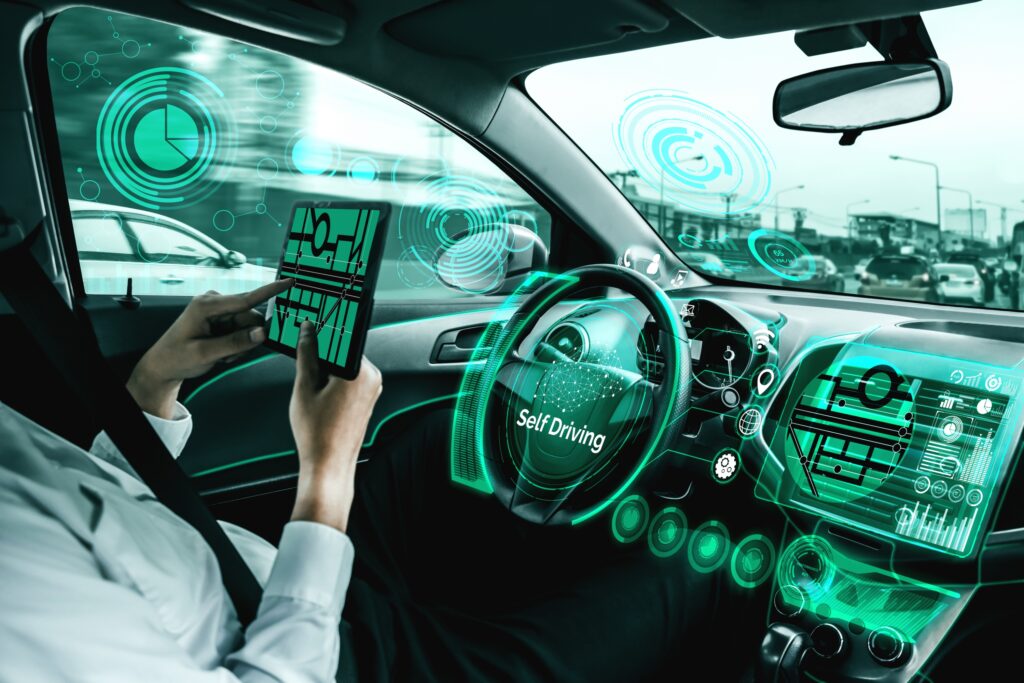 Autonomous vehicle interior with AI perception systems monitoring the road, surrounding vehicles, and driving environment.