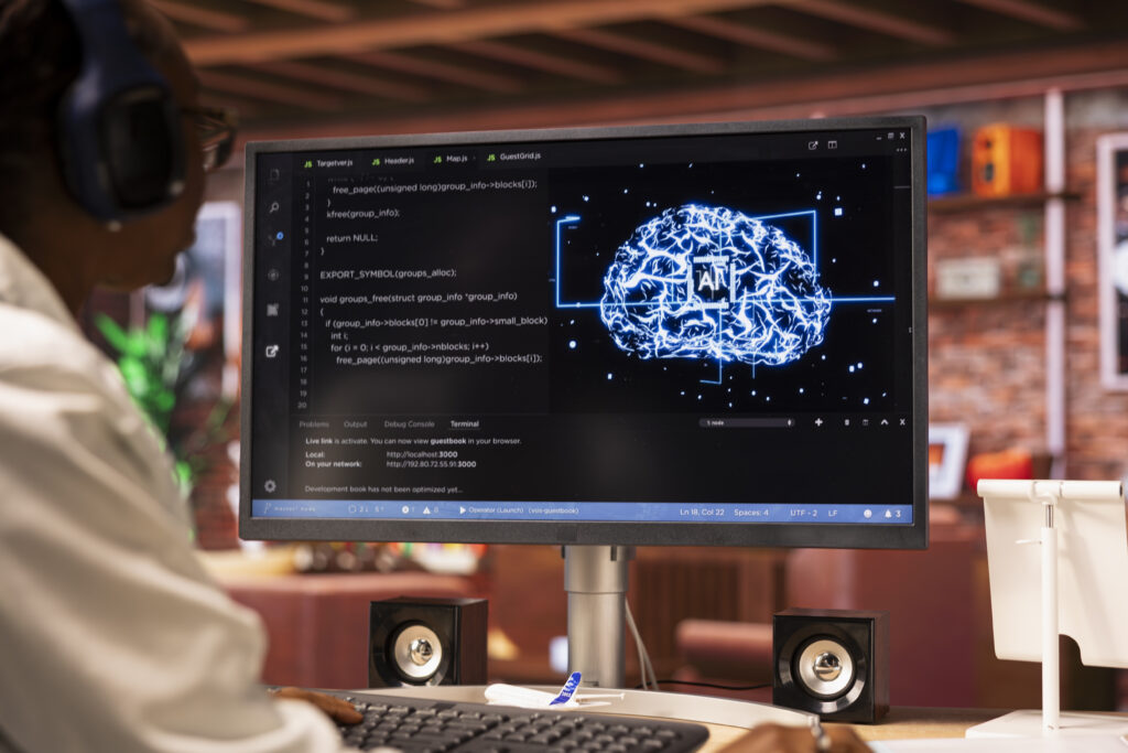 Person working with AI data and code on a computer screen.